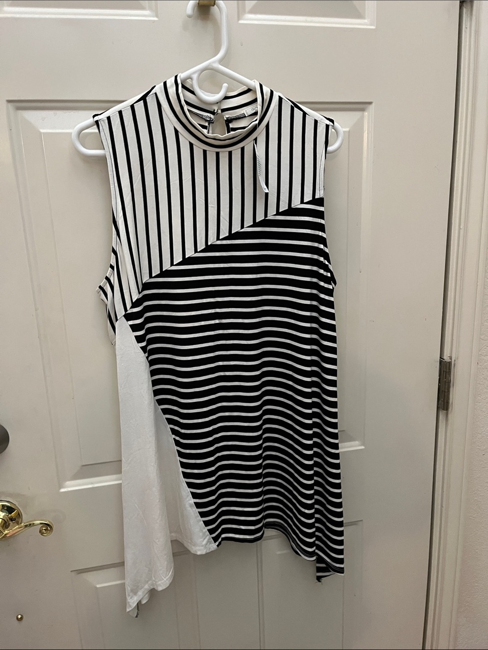 Sleeveless Black & White Striped Mock Neck Top sold at Stein Mart